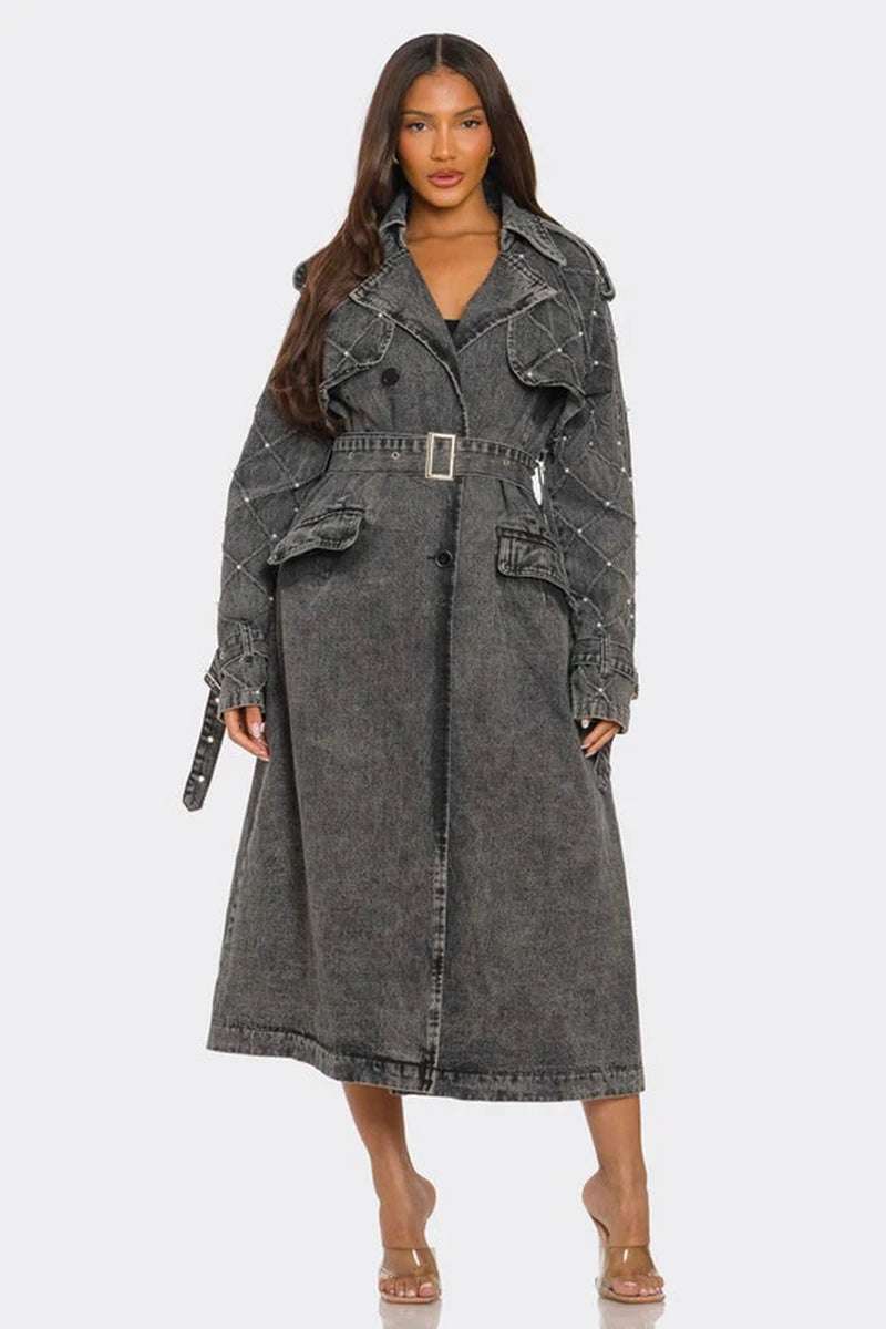 Womenβs edgy distressed longline denim trench coat with quilted sleeves and studs in faded charcoal-black wash.
