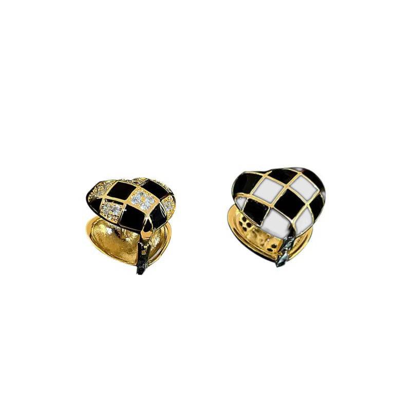 Heart-shaped plaid stud earrings in black, white, and gold with diamond accents, copper material, electroplated finish