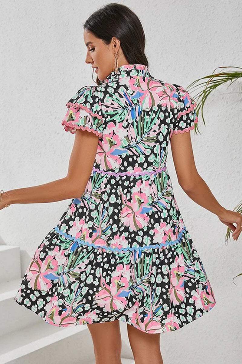 Back view of a women’s floral ricrac embellished tiered mini dress, featuring vibrant prints and short sleeves.