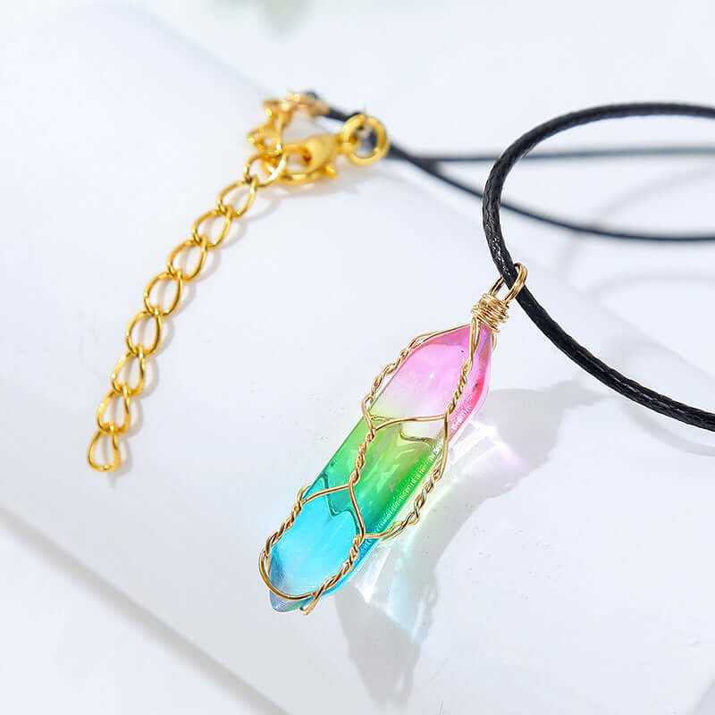 Colorful crystal pendant necklace on black cord with gold chain for women, featuring a geometric design in pink and green.