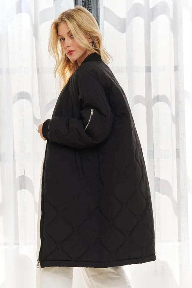 Women’s zip-up utility long jacket in black, featuring a stylish quilted design and practical pockets.