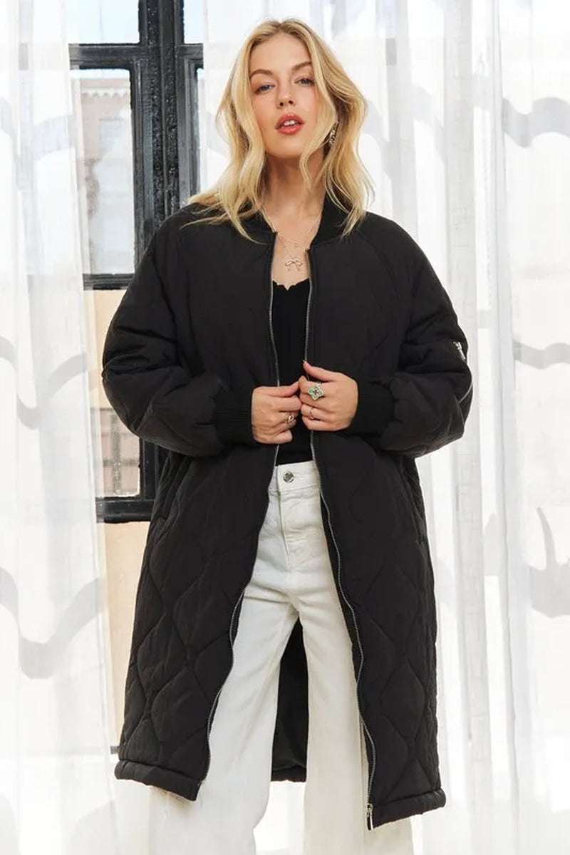Stylish women's black zip-up long utility jacket featuring a modern silhouette and cozy quilted design.