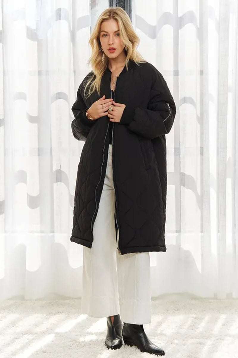 Women’s zip-up utility long jacket in black, featuring a cozy quilted design and long length for extra coverage.