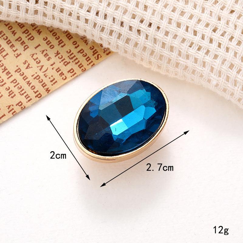 Bright blue oval gem embellishment with gold trim, perfect for stylish shoe ornaments and accessories, measuring 2cm x 2.7cm.