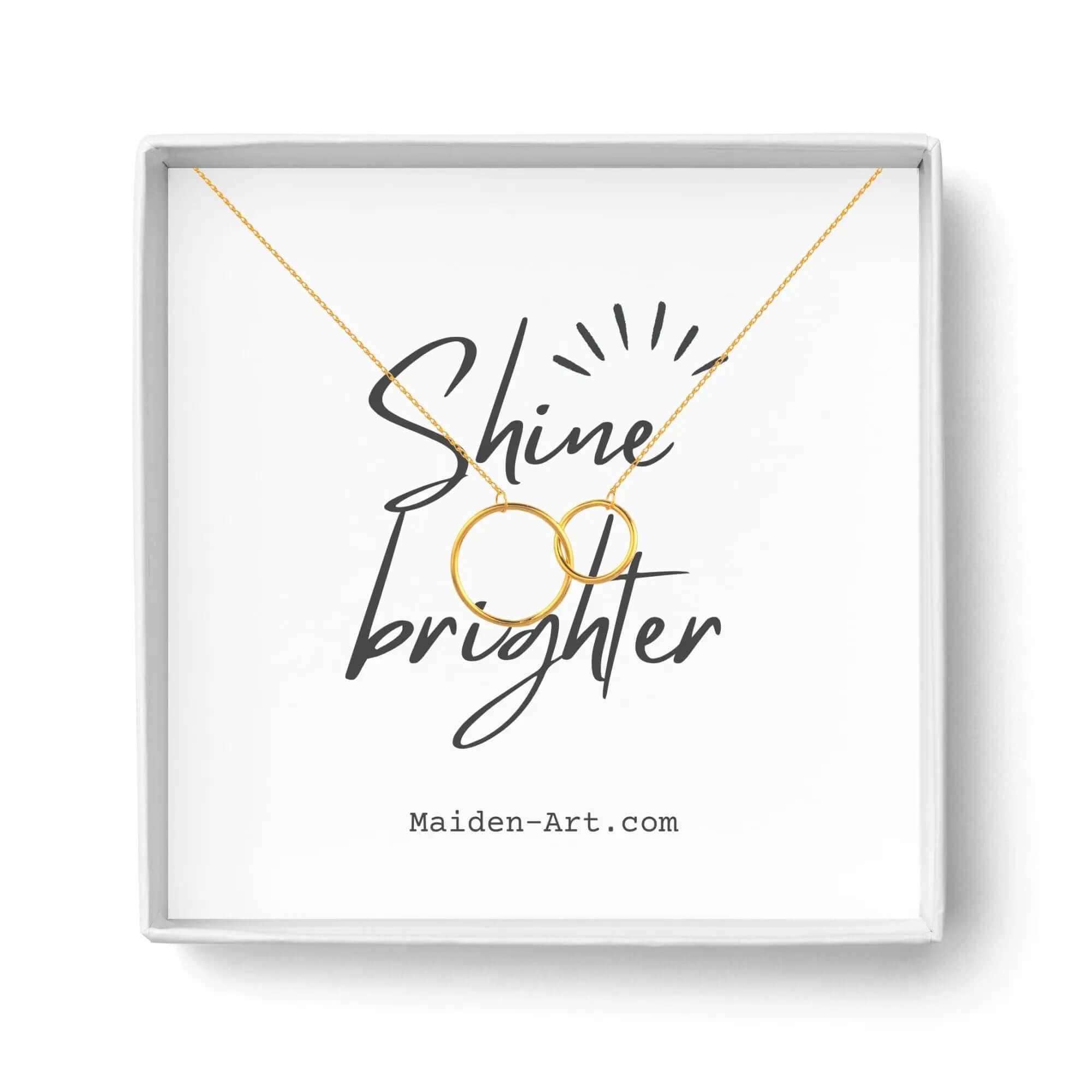 14K gold plated interlocking circle pendant necklace in a branded gift box with 'Shine Brighter' message.