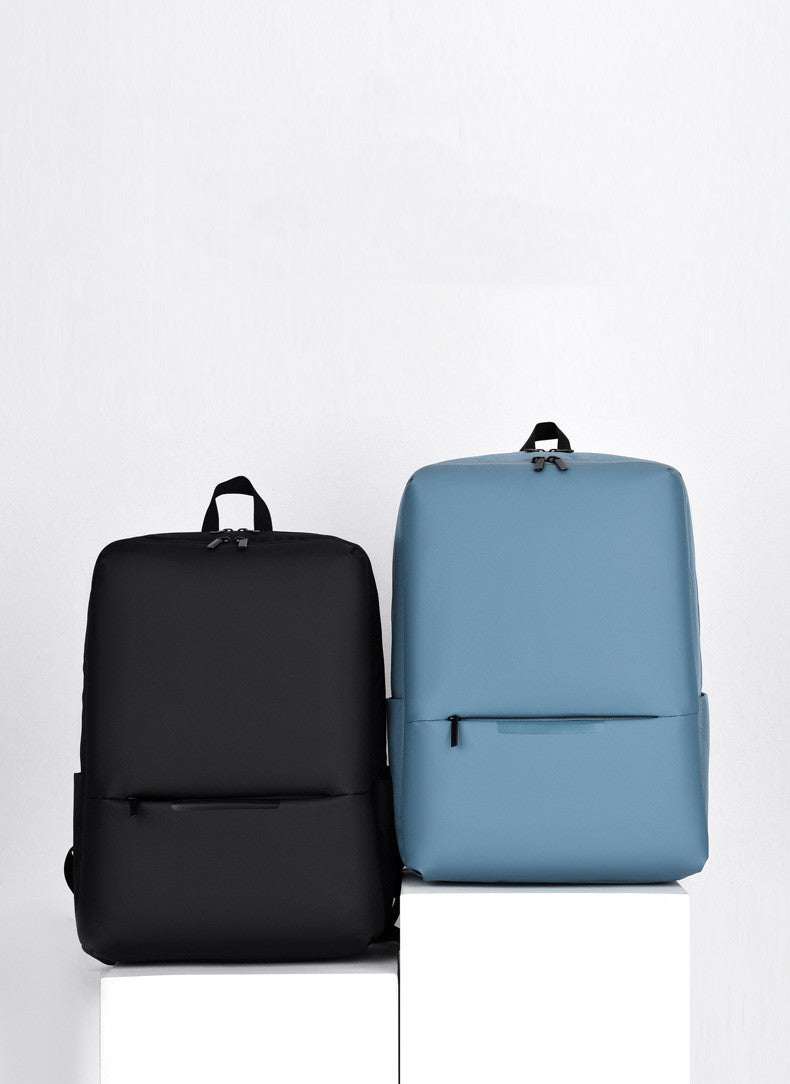 Large-capacity business laptop backpack in black and blue colors displayed side by side.