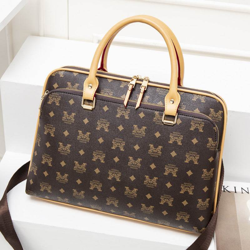 lady business laptop bag in brown synthetic leather with stylish design and dual handles.