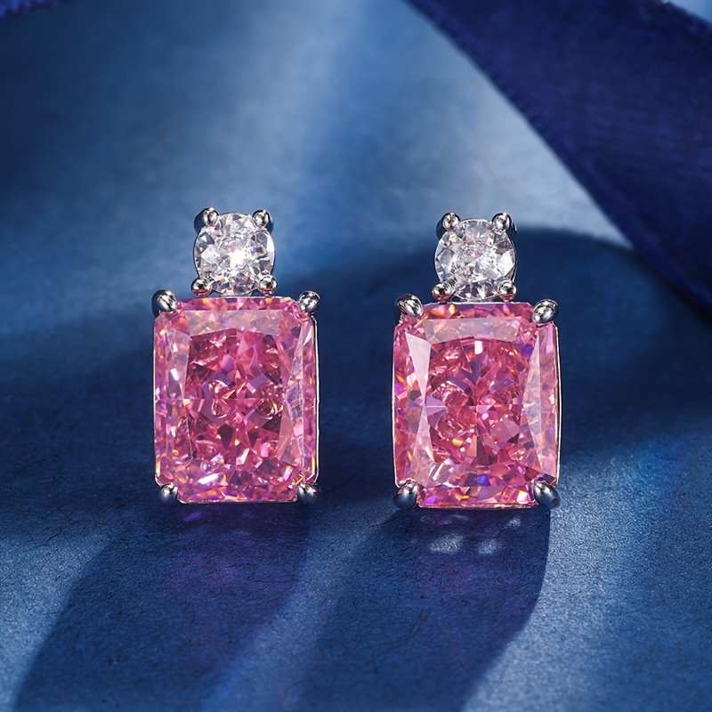 Elegant pink diamond earrings with sparkling white diamonds set in sterling silver, perfect for any occasion.