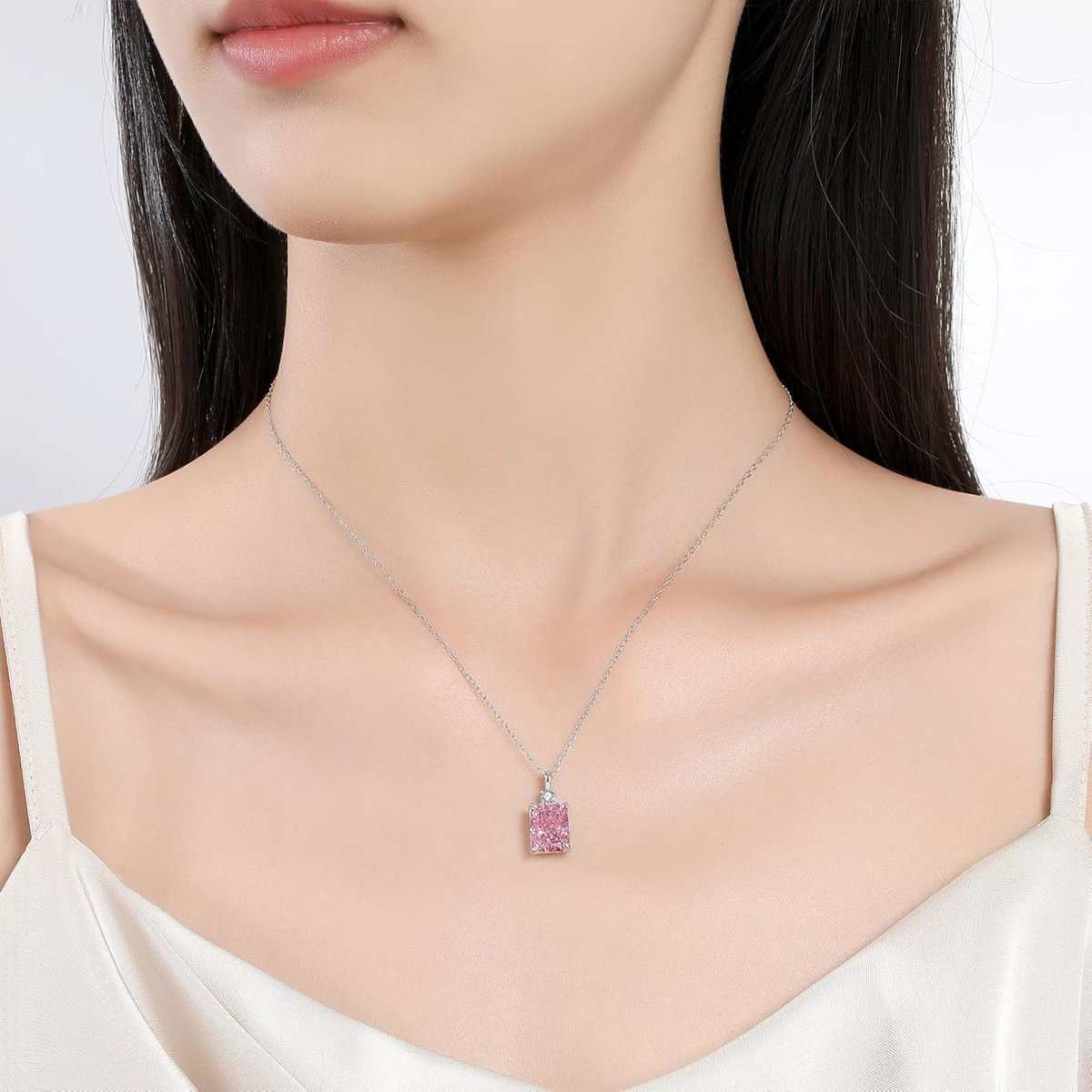 18K gold plated necklace with imitation pink diamond on a silver chain, elegantly worn on a model's neck.