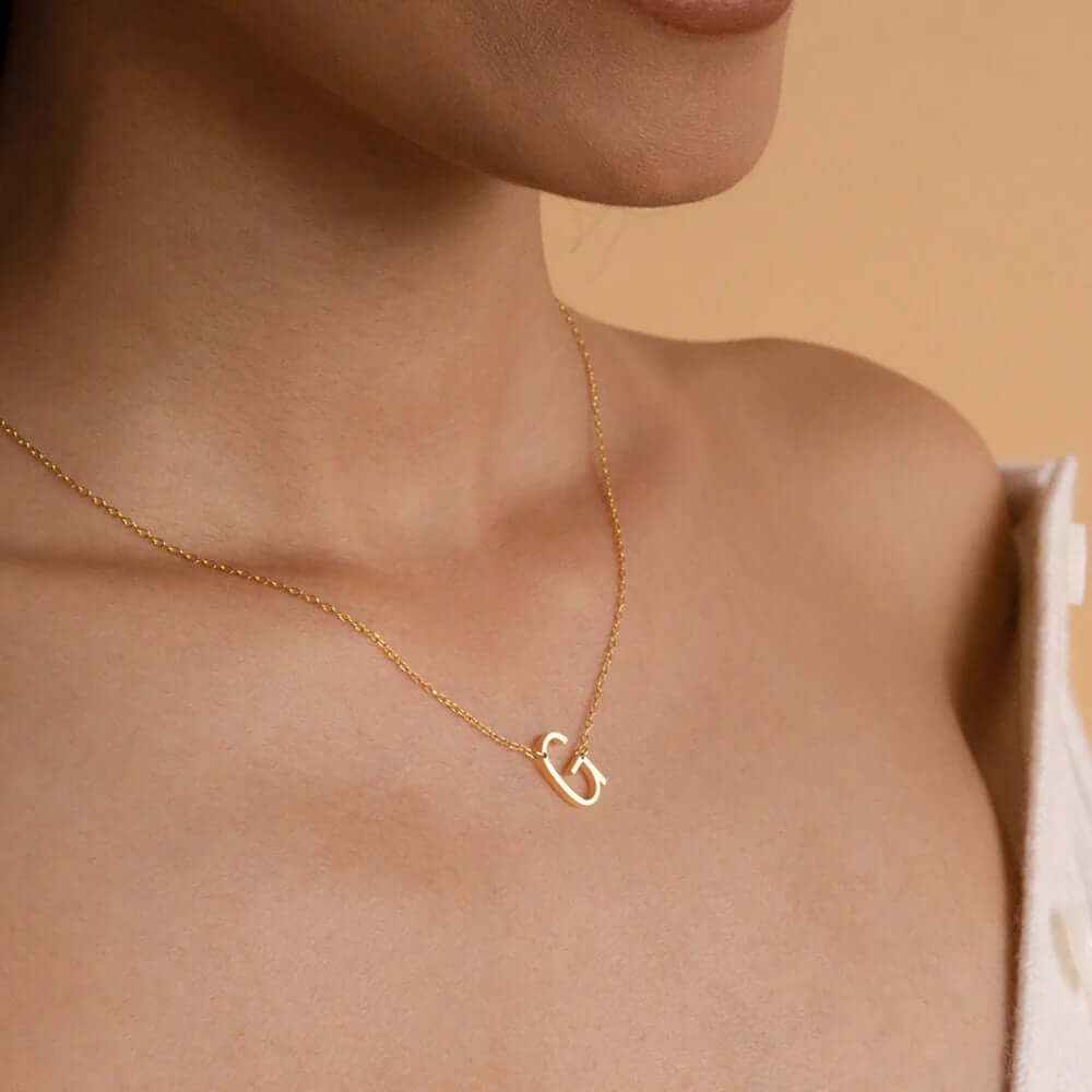 Elegant 18k gold plated sideways initial letter necklace worn on a model, showcasing personalized jewelry style.