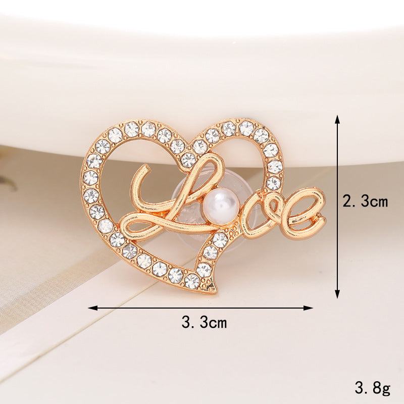 Gold heart-shaped shoe ornament with 'Love' inscription and pearl embellishment, perfect for decorating shoes.