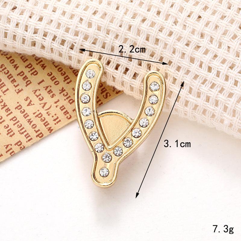 Gold shoe ornament in a Y-shape, adorned with clear crystals, measuring 2.2cm x 3.1cm, perfect for elevating footwear.