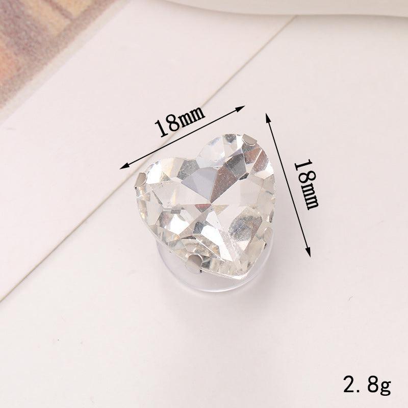 Heart-shaped crystal ornament measuring 18mm, perfect for enhancing shoe designs and accessories.