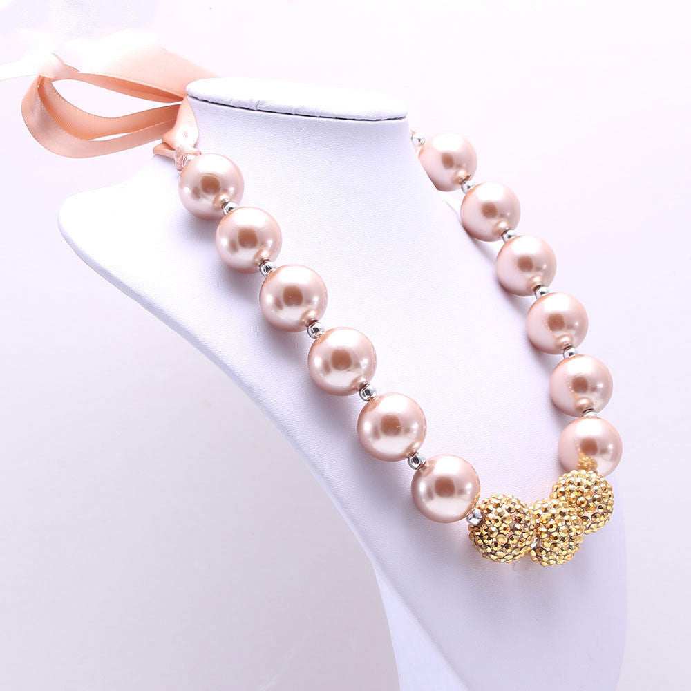 European Style Children's Pearl Necklace with large pink beads and gold accents displayed on white bust