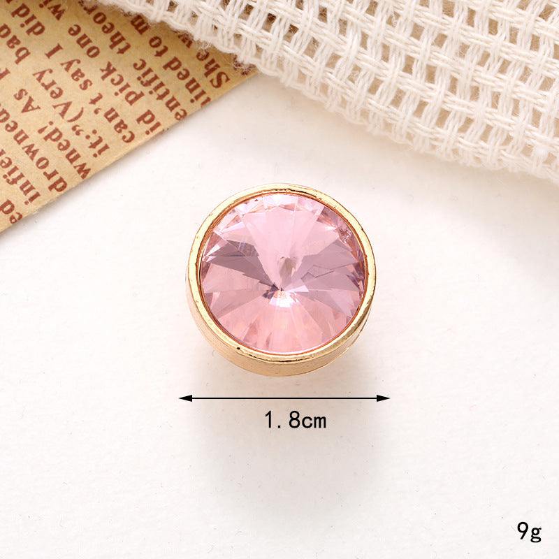Bright pink crystal shoe ornament measuring 1.8cm, set in a golden base, perfect for adding glam to footwear.
