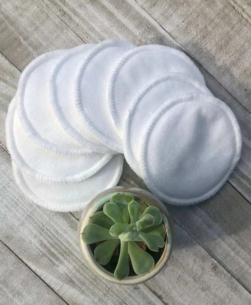 Set of 5 eco-friendly reusable facial rounds pads next to a succulent plant on wooden surface.