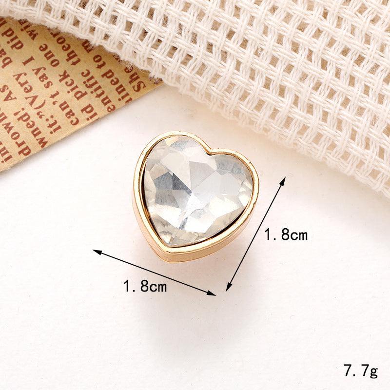 Heart-shaped crystal shoe ornament with gold trim, measuring 1.8cm, perfect for decorating shoes.