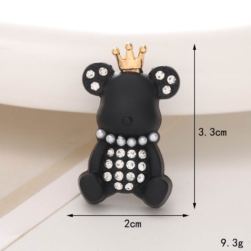 Cute black bear shoe ornament with a crown and pearl accents, perfect for adding whimsy to footwear.