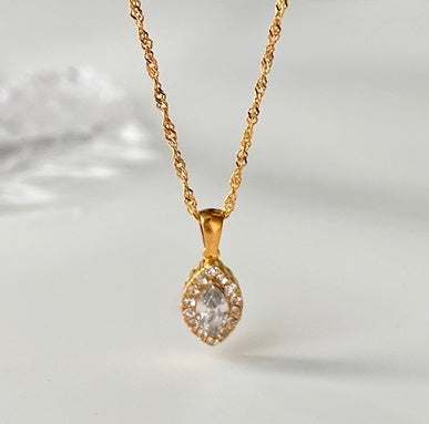 Durable titanium steel chain necklace with sparkling zircon pendant in elegant golden setting.