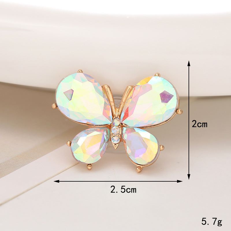 Colorful butterfly shoe ornament with shimmering crystals in gold setting, measuring 2.5cm x 2cm.
