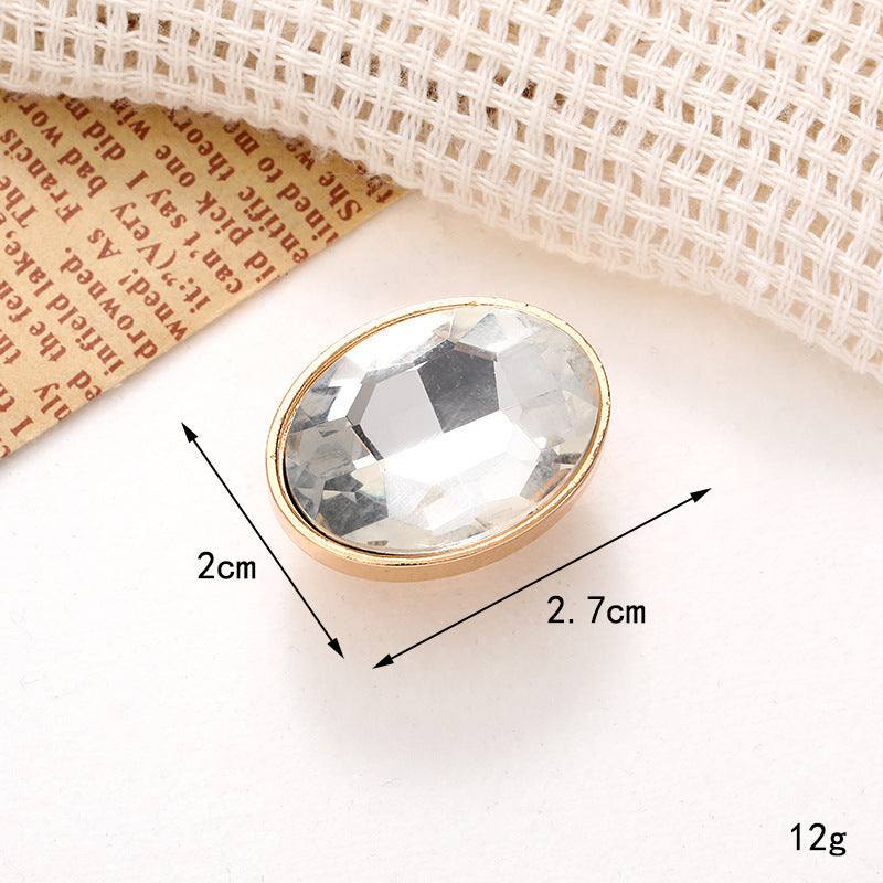 Oval crystal shoe ornament with gold trim, measuring 2cm by 2.7cm, perfect for decorating footwear.