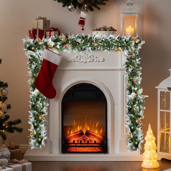 pre-lit snow flocked Christmas garland adorning a decorated fireplace with stockings and festive lights.