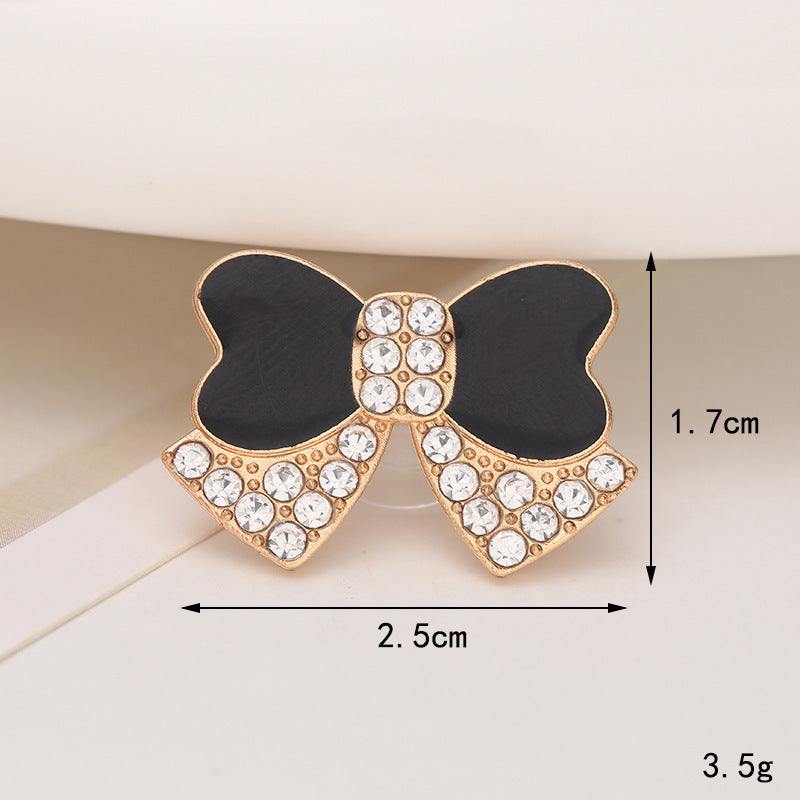 Elegant black and gold bow shoe ornament with rhinestones, perfect for adding a stylish accent to footwear.