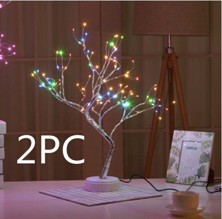LED Christmas tree night light with 108 multi-color LED lights on a white base, glowing brightly on a table at night