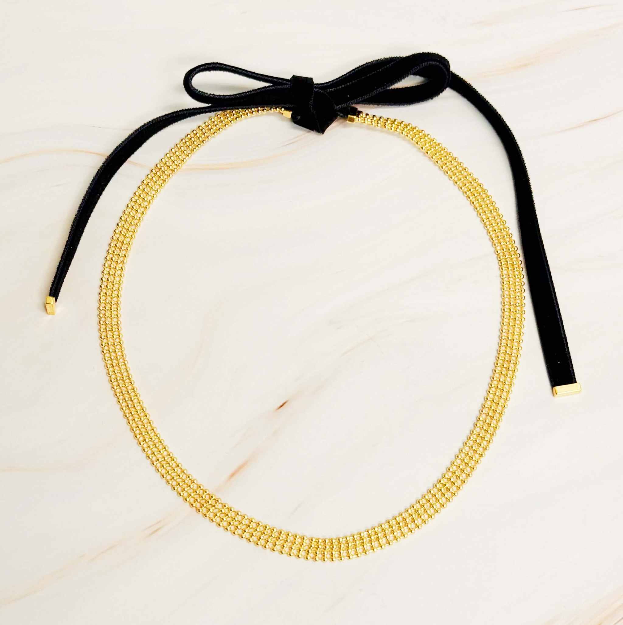 Adjustable gold tie back choker necklace with velvet sash ties for versatile styling options.
