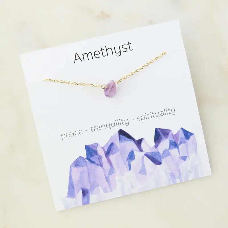 Amethyst charm necklace on card, highlighting peace, tranquility, and spirituality with delicate gold chain.