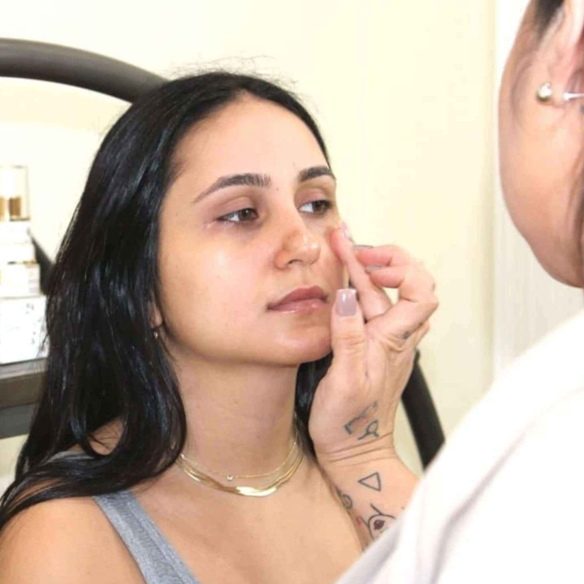 Woman receiving Anti-Puffiness Eye Serum treatment to reduce puffiness and dark circles around the eyes.
