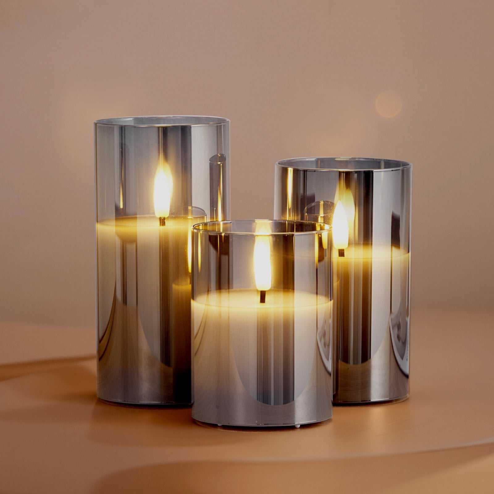 battery operated flameless LED candles in sleek metallic holders, glowing softly on a table.