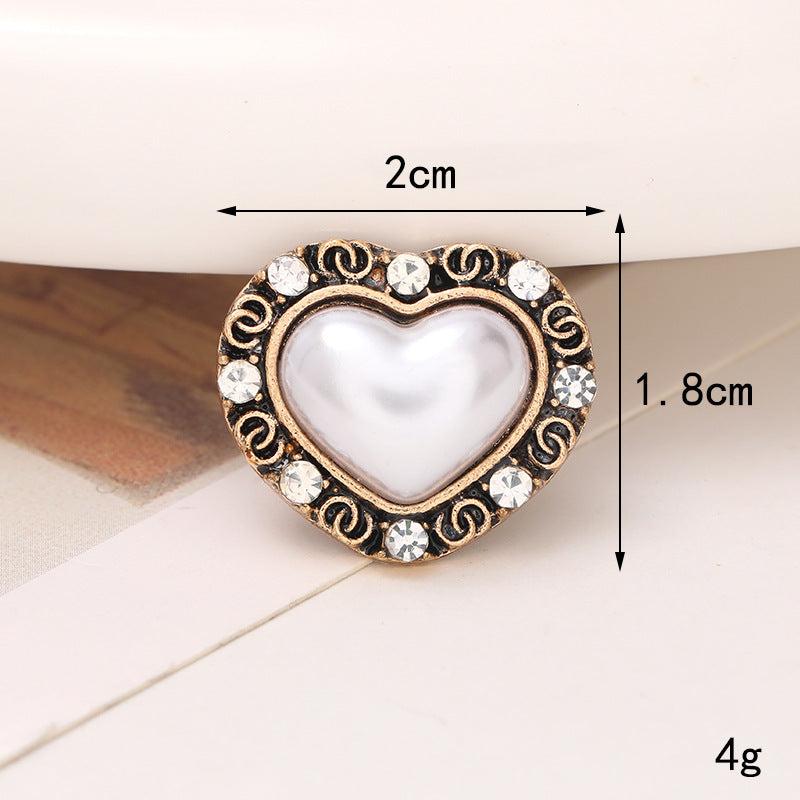 Heart-shaped shoe ornament featuring a pearl center and rhinestone accents, measuring 2cm x 1.8cm, ideal for footwear embellishment.
