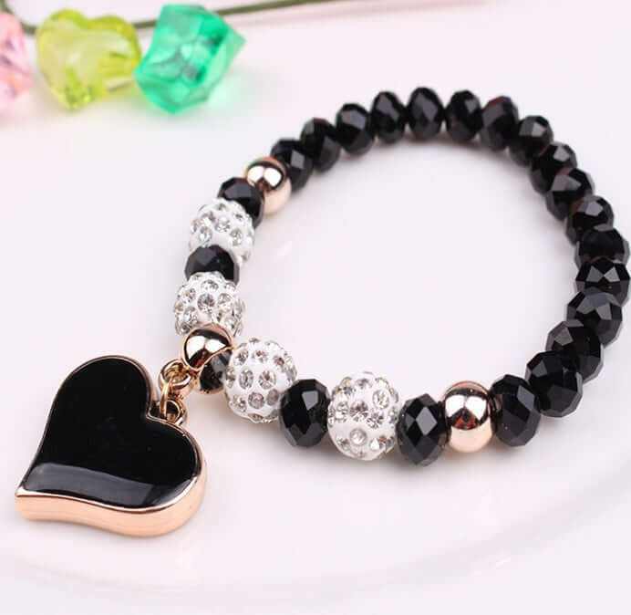 Elegant black heart crystal bracelet with sparkling beads and gold accents, perfect for adding sophistication to any outfit.