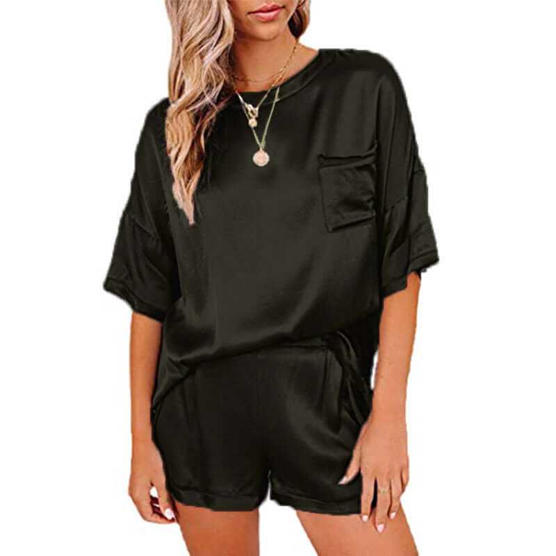 Women’s short sleeve silk pajama set in black, featuring a relaxed fit T-shirt and shorts for comfortable sleepwear.