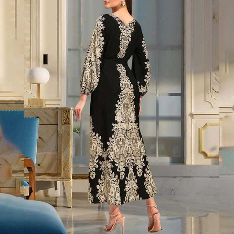 Back view of a women's black floral print maxi dress with long sleeves and a tiered design, showcasing a bohemian style.