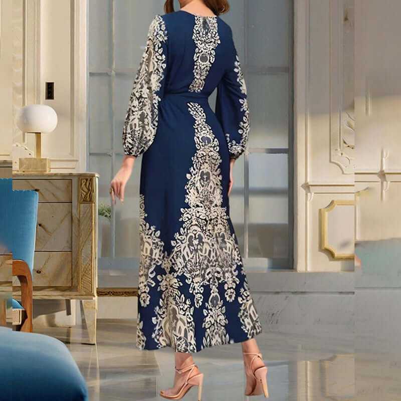 Back view of a women's bohemian floral print maxi dress in navy with long sleeves and a tiered design.