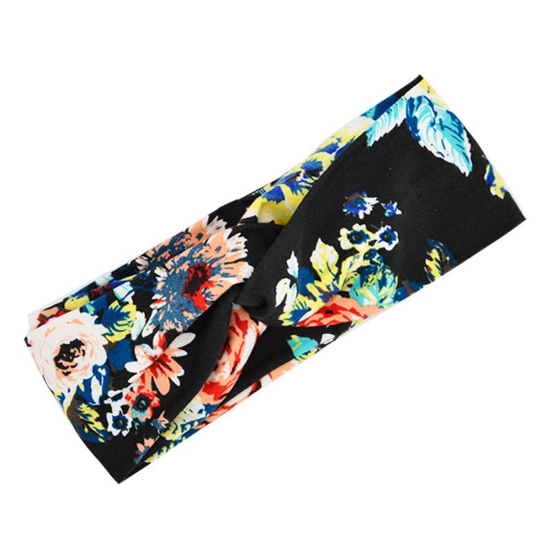 Boho chic floral cross fabric headband with colorful flower print on black background