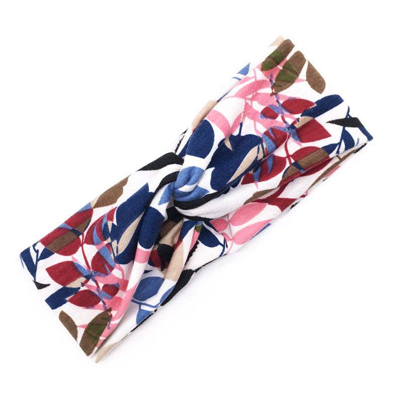 Boho Chic floral cross headband with pink, blue, red, and brown leaf pattern fabric accessory