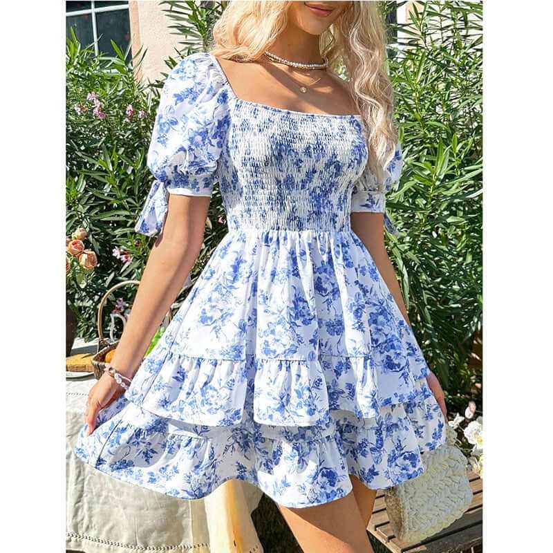 Women's puff sleeve square neck smocked mini dress in blue floral print with ruffle hem, perfect for summer outings.