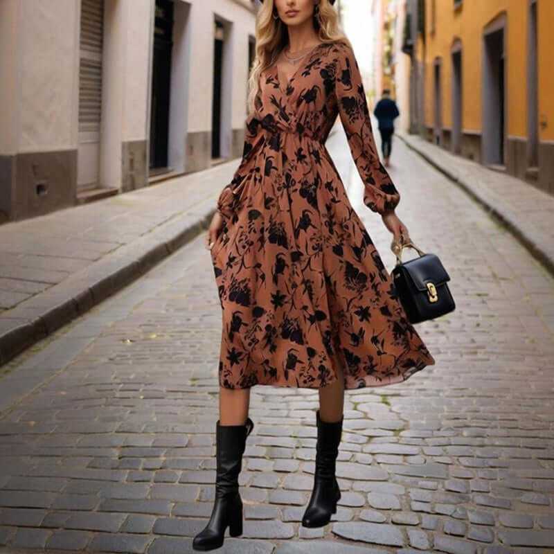 Women’s boho V-neck floral maxi dress with cuffed sleeves and side slit, styled with high boots and handbag.