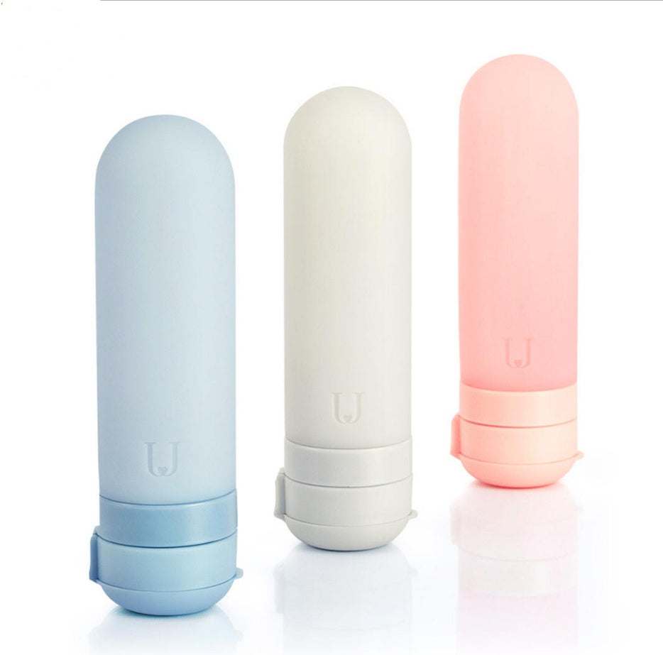Colorful silicone bottled travel cosmetics storage bottles in blue, white, and pink