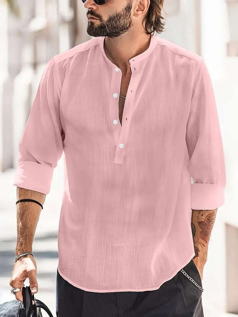 man wearing pink breathable button-down shirt with rolled sleeves and sunglasses