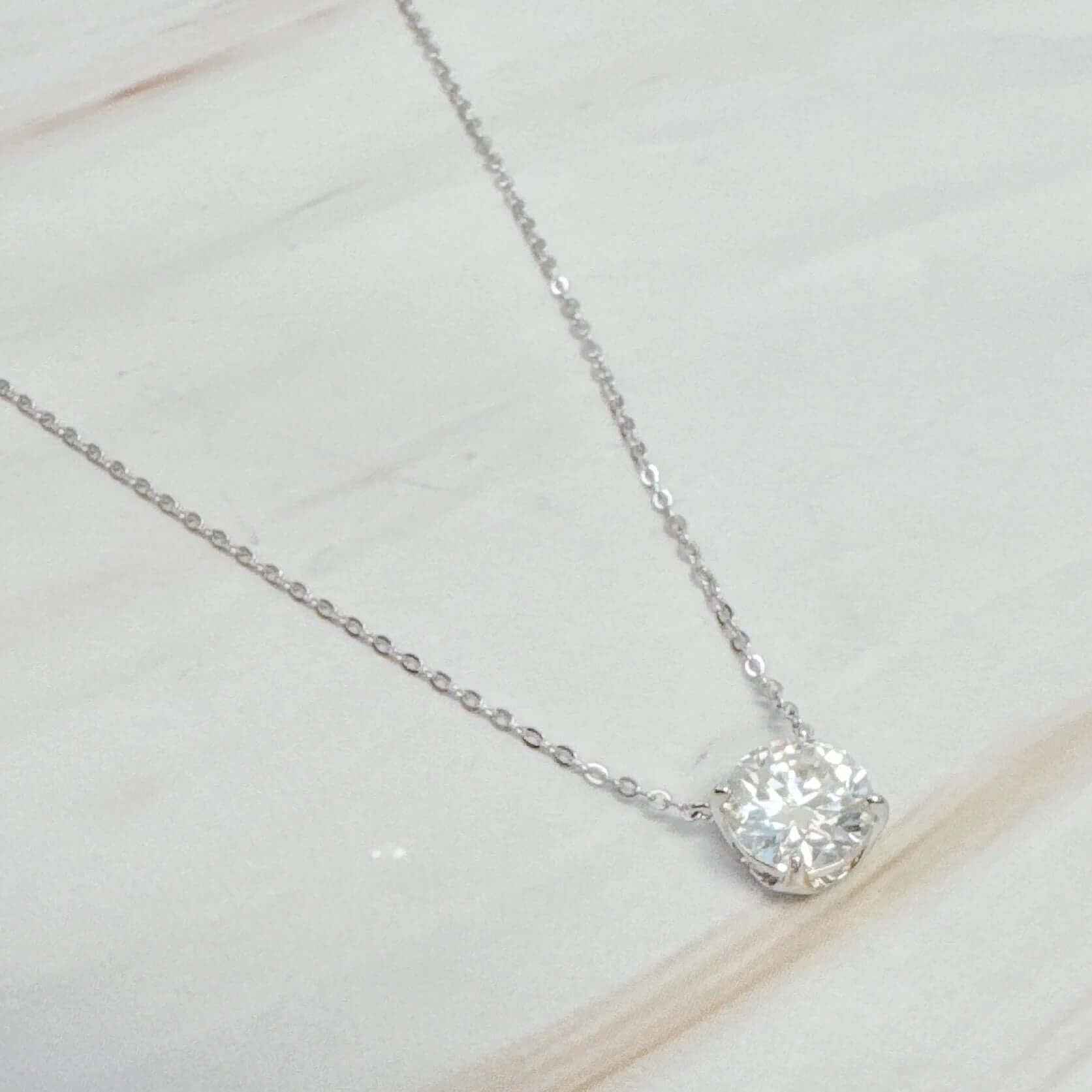 Brilliant Moissanite Floating Pendant Necklace on a dainty silver chain, showcasing a sparkling 1.5 carat stone.