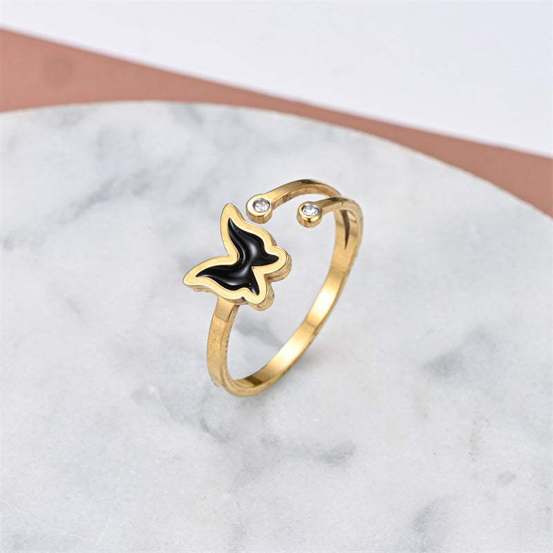 Fashionable elegant stainless steel gold ring with black butterfly design and small crystals