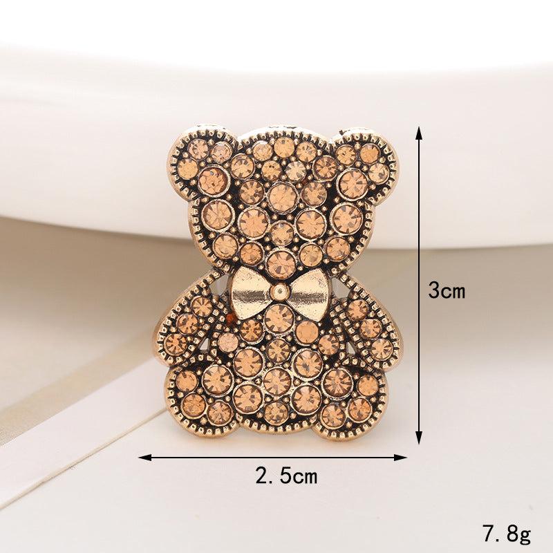 Gold teddy bear brooch adorned with sparkling crystals, measuring 2.5cm by 3cm, perfect for accessories.