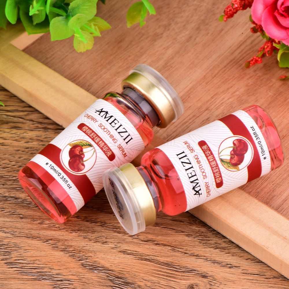 Cherry hyaluronic acid skin care moisturizing serum bottles on wooden surface with green and red flowers background