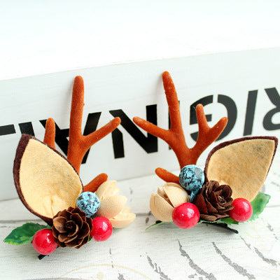 Children's Christmas hair clip with fabric antlers and festive decorations