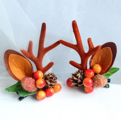 Children's Christmas hair clip with fabric antlers and festive berry decoration
