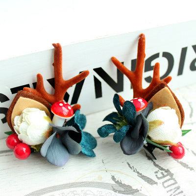 Children's Christmas hair clip with fabric antlers, flowers, and red berries festive hairpin accessory